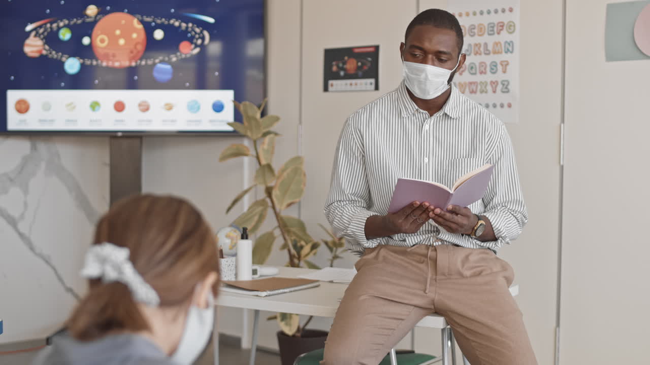 Afro-American Science Teacher Giving Lesson in School