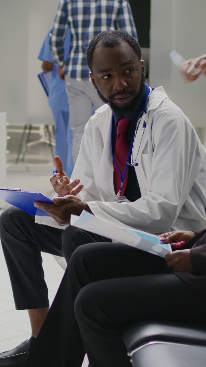 Vertical video: Professional medic consulting african american woman in health center