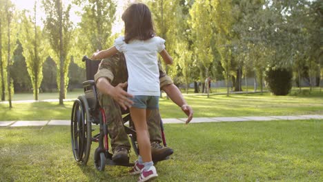 children and their mom running to disabled retired military dad