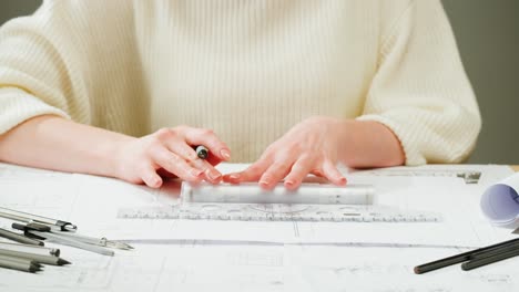 person working on architectural plans