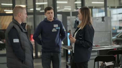 female manager discussing vehicle repair with mechanic in auto repair shop