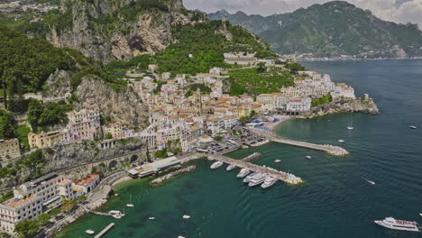 amalfi italy aerial v7 flyover picturesque coastal town center capturing charming mediterranean architecture, harbor, terraced hillsides and azure tyrrhenian sea - shot with mavic 3 cine - may 2023