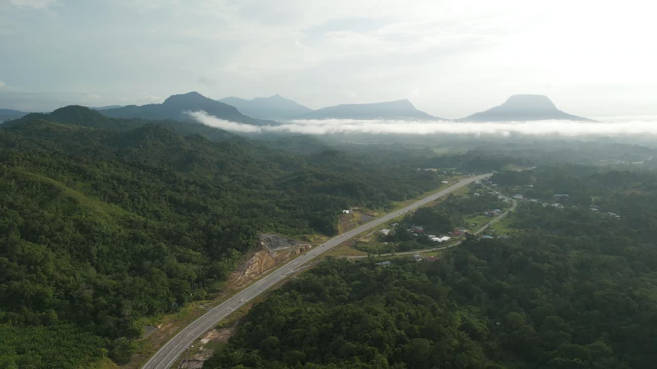 Beautiful Drone View Of Bau To Lundu Pan Borneo Highway During Morning Sunset With Mountain And Valley, Green Forest,Sarawak, Borneo.