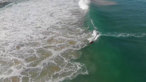 bodyboarder rides wave, 360 spin