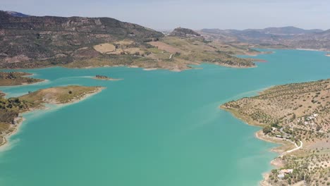 aerial view of a turquoise reservoir in the spanish mountains