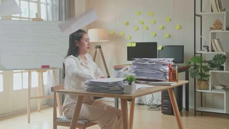 pressure asian woman throw away the paper while working hard with documents at the office