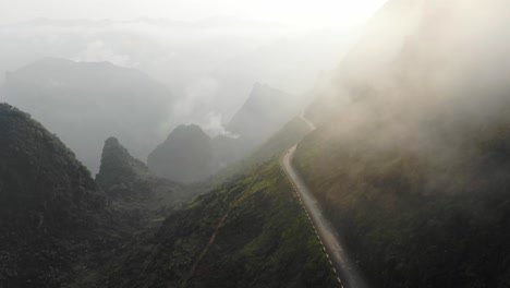 low clouds on ma pi leng pass vietnam with motorbike driving, aerial