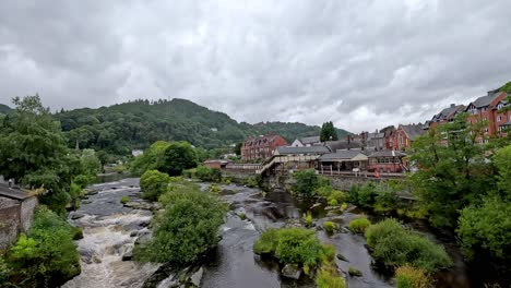 a picturesque river flowing through llangollen, wales