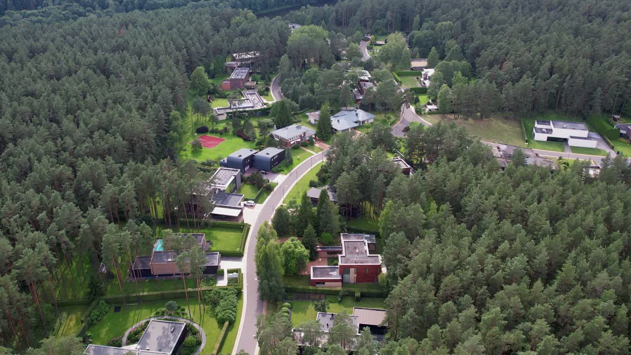 High-altitude drone view showcasing premium forest-side homes and bold contemporary architecture, ideal for luxury real-estate, upscale neighbourhood branding, and modern design projects