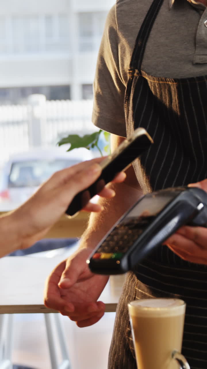 Woman paying bill through NFC technology