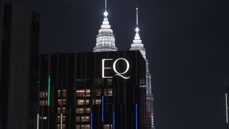 drone shot orbiting the eq hotel logo, nighttime in kuala lumpur, malaysia
