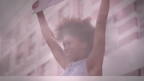 Animation-of-lights-and-lens-flare-over-african-american-woman-holding-sign-at-protest-in-city