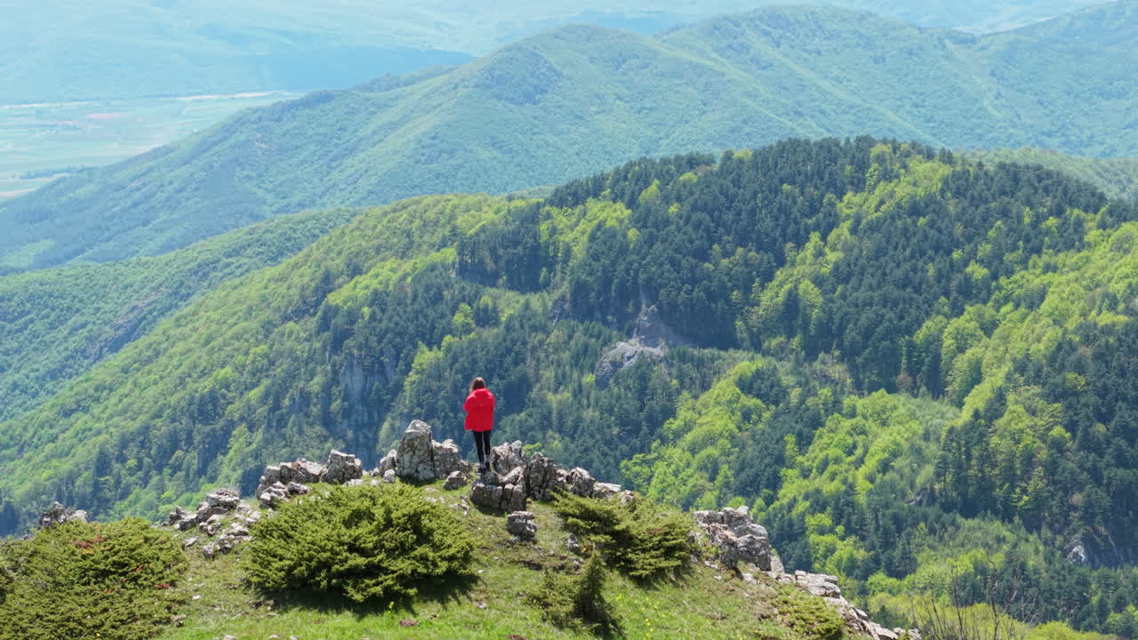 Scene of a young traveler enjoying the fresh mountain air and expansive views at Beklemeto. A symbol of wanderlust, outdoor adventure, and personal freedom.