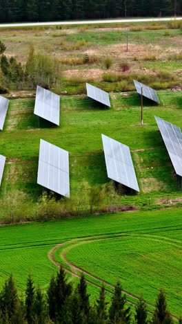 solar panels in green fields, aerial drone vertical view