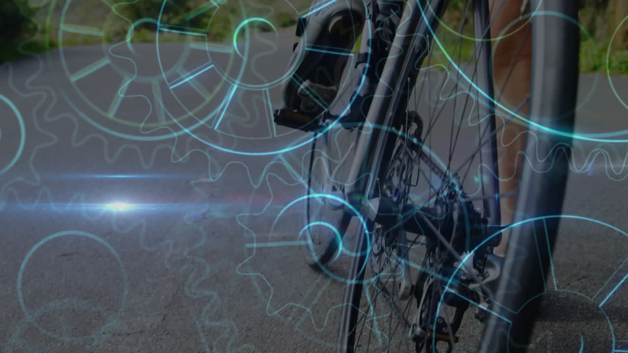 ruedas de engranajes girando contra una mujer montando en bicicleta