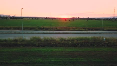 Aerial-view-of-motorcycles-cross-the-highway-at-breakneck-speed-at-sunset