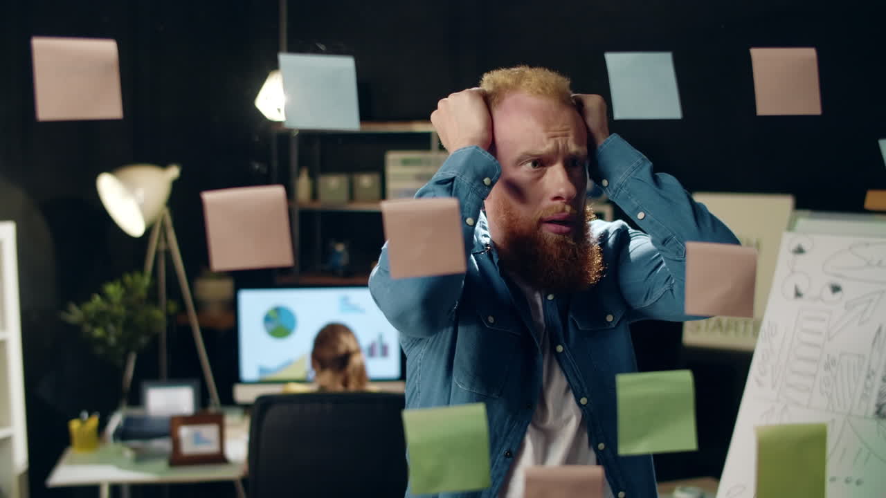 близкий усталый бизнесмен нервничает из-за проекта в офисе хипстера