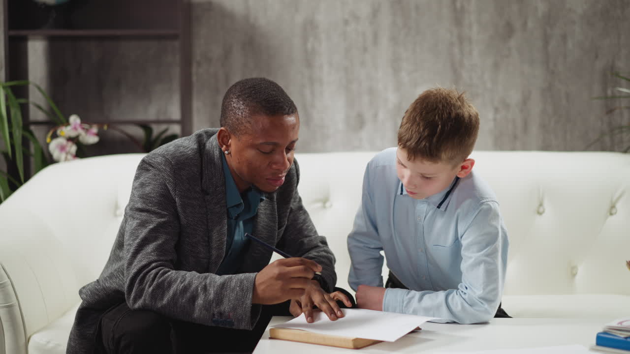 Black man conducts private English lesson to little boy