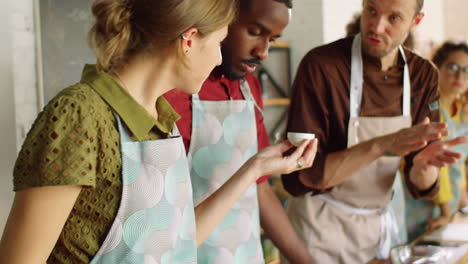 diverse students smelling ingredient on cooking master class