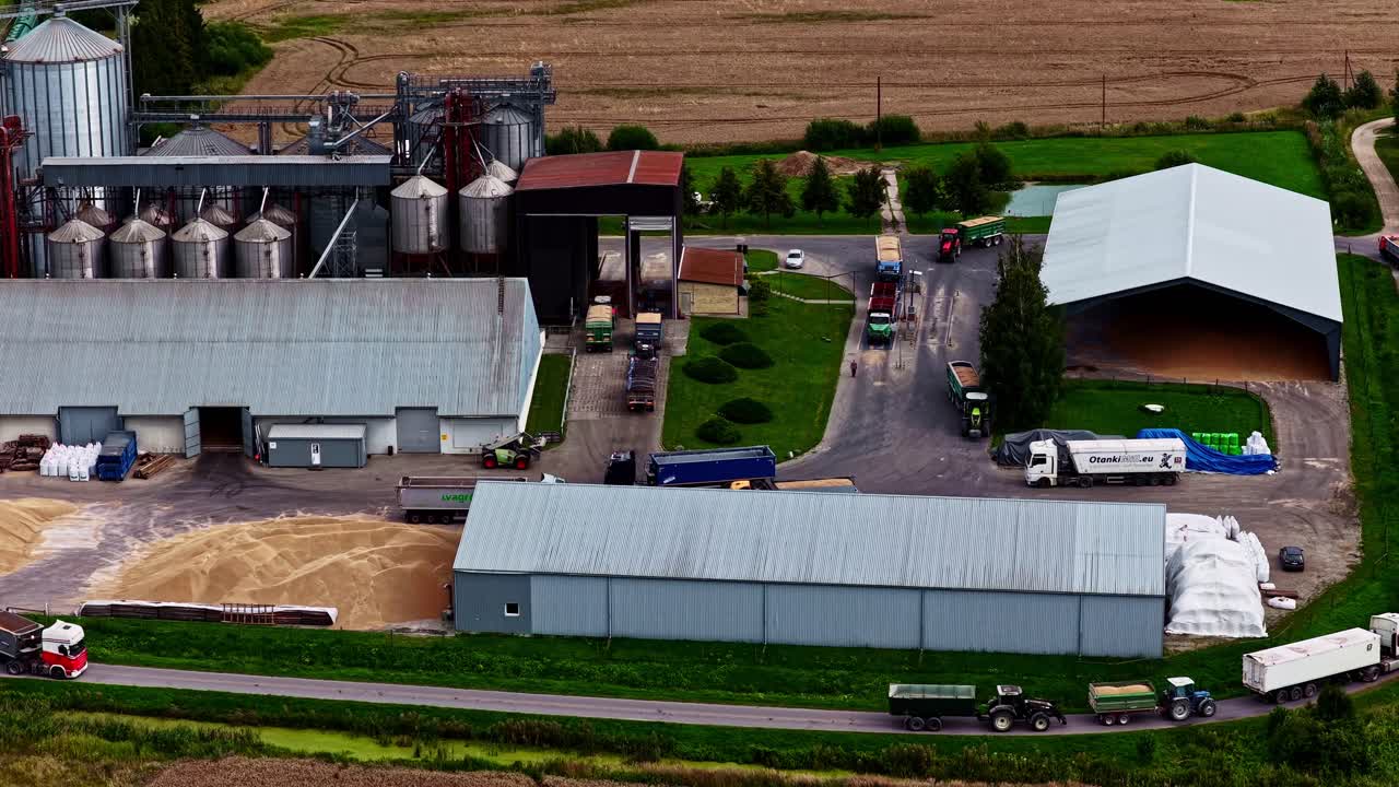 Aerial View of a Farm with Grain Silos and Trucks
