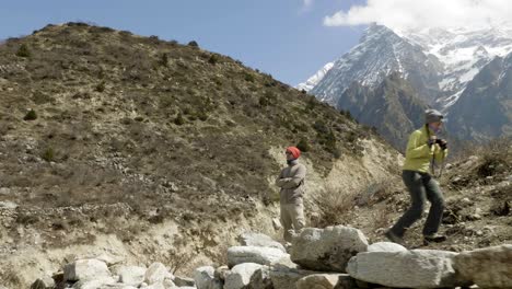 couple do pictures among the mountains in nepal. manaslu area.