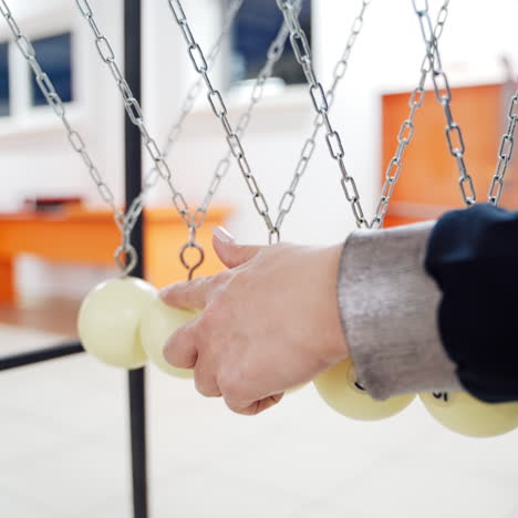 newton's cradle showing laws of physics in motion. museum of science and newton pendulum