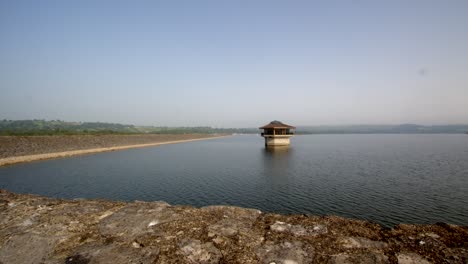 Wide-shot-of-Carsington-Water-with-the-Water-Valve-Tower,-Draw-Off-Tower-and-the-dam-to-the-left