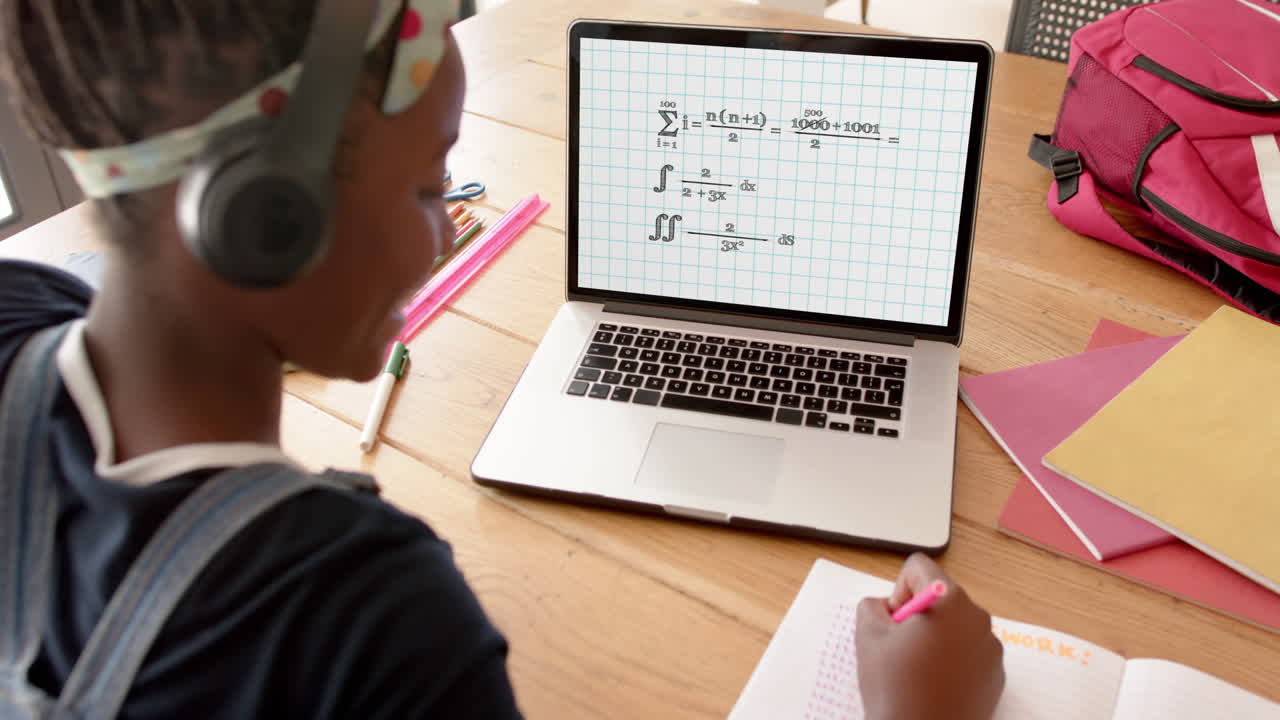 Composition of african american schoolgirl on laptop online learning with math text