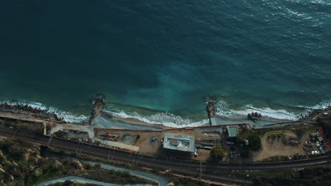 aerial view of coastal construction and train tracks