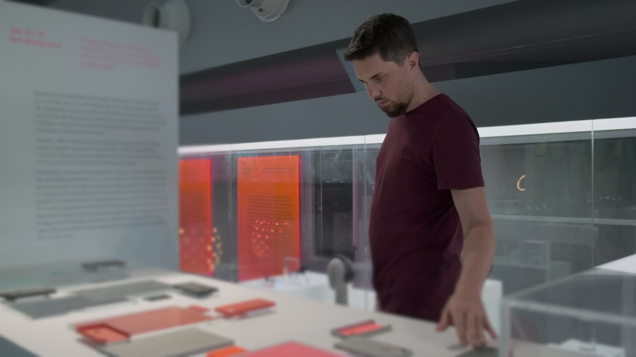 Man Looking at Exhibits in a Modern Design Museum