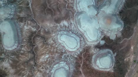 bird's eye view of bentonite hills in cathedral valley, capitol reef national park, utah - drone orbit