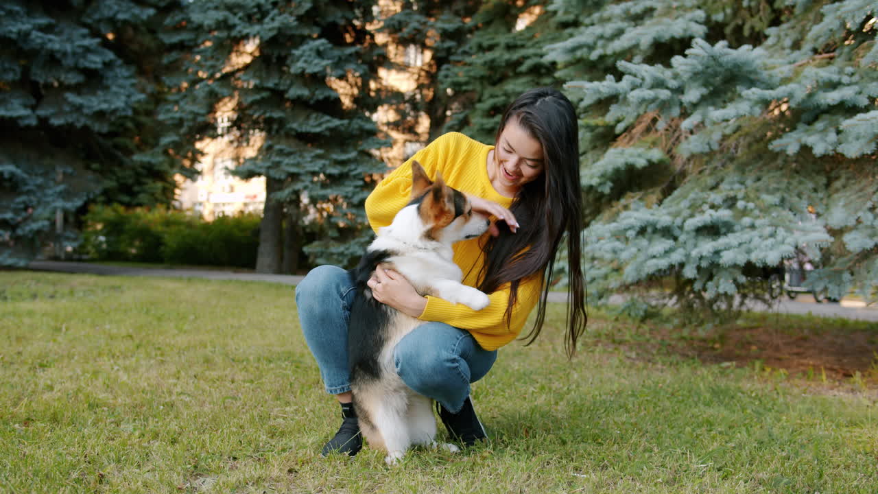 Woman and her Corgi in a Park