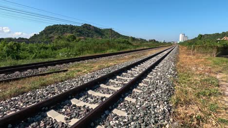 progression along empty railway tracks in nature