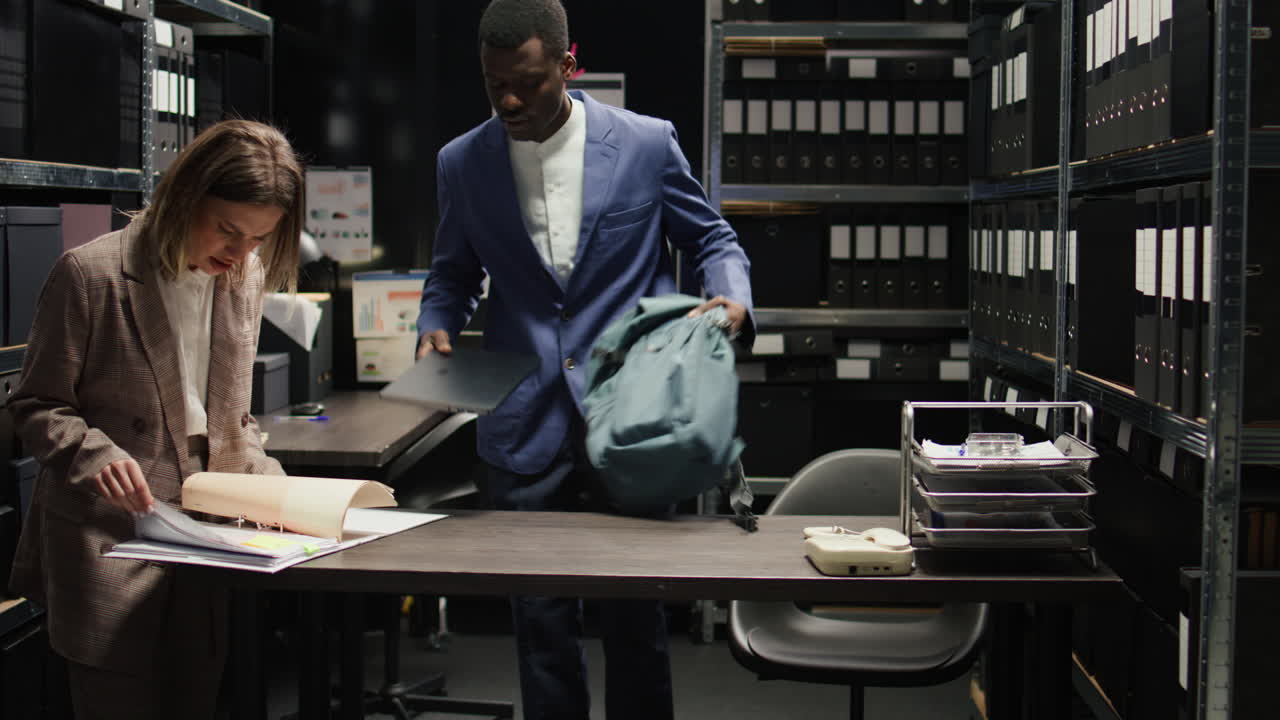 People working in an office with filing cabinets and documents