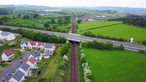 trains passing under busy highway, scotland