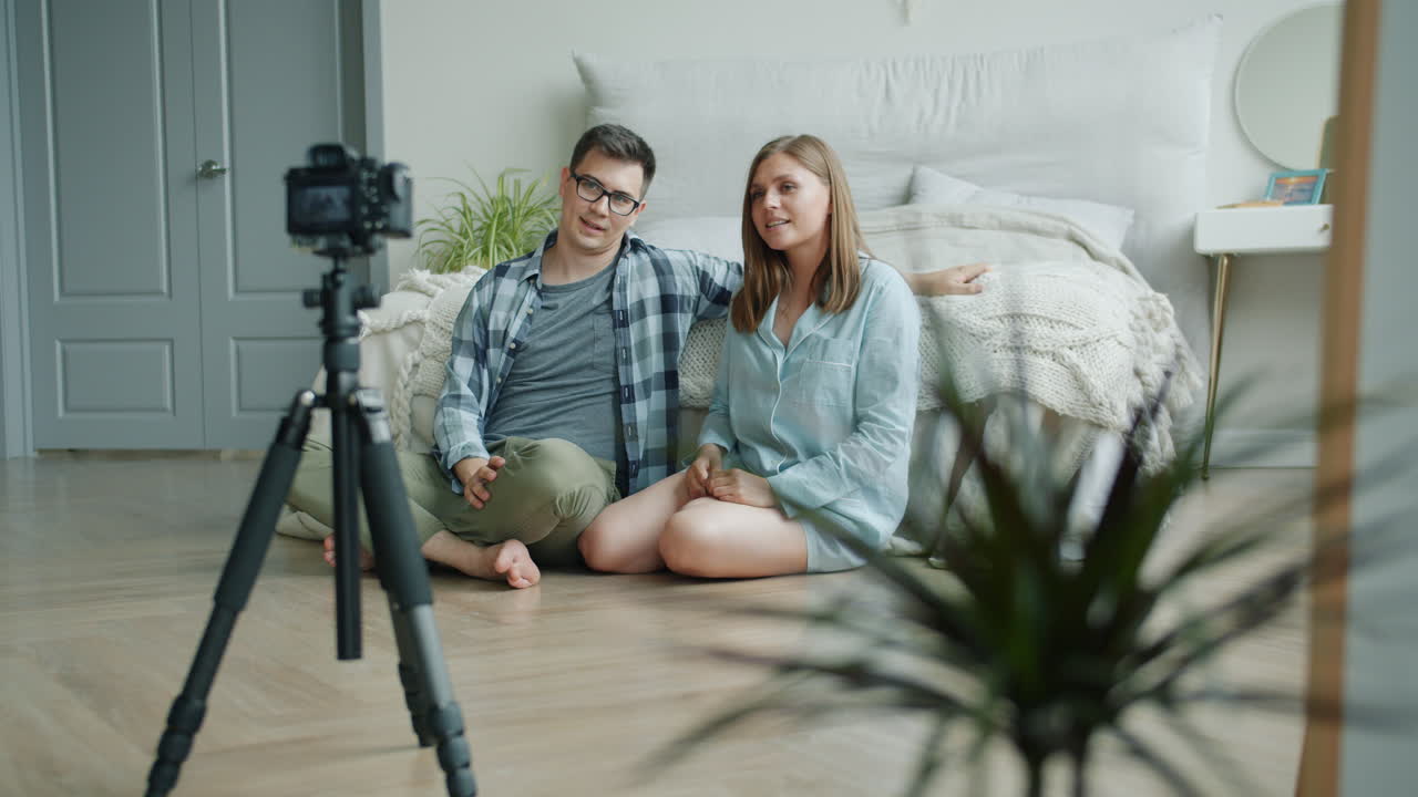 Couple Making a Video Blog in Their Bedroom