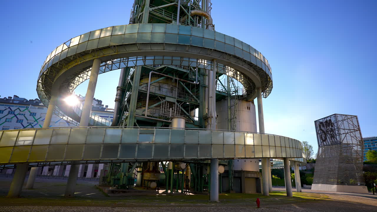 Close view of spiral walkway around Chamine da Refinaria da GALP with metal pipes and green steel construction in Lisbon