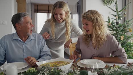 caucasian adult daughter talking with senior dad in christmas time.