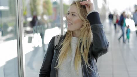 Pretty-woman-looking-at-shop-window