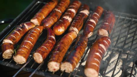 grilling tasty sausages on barbecue grill