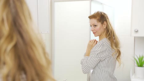 mature beautiful woman looking at herself in the mirror.