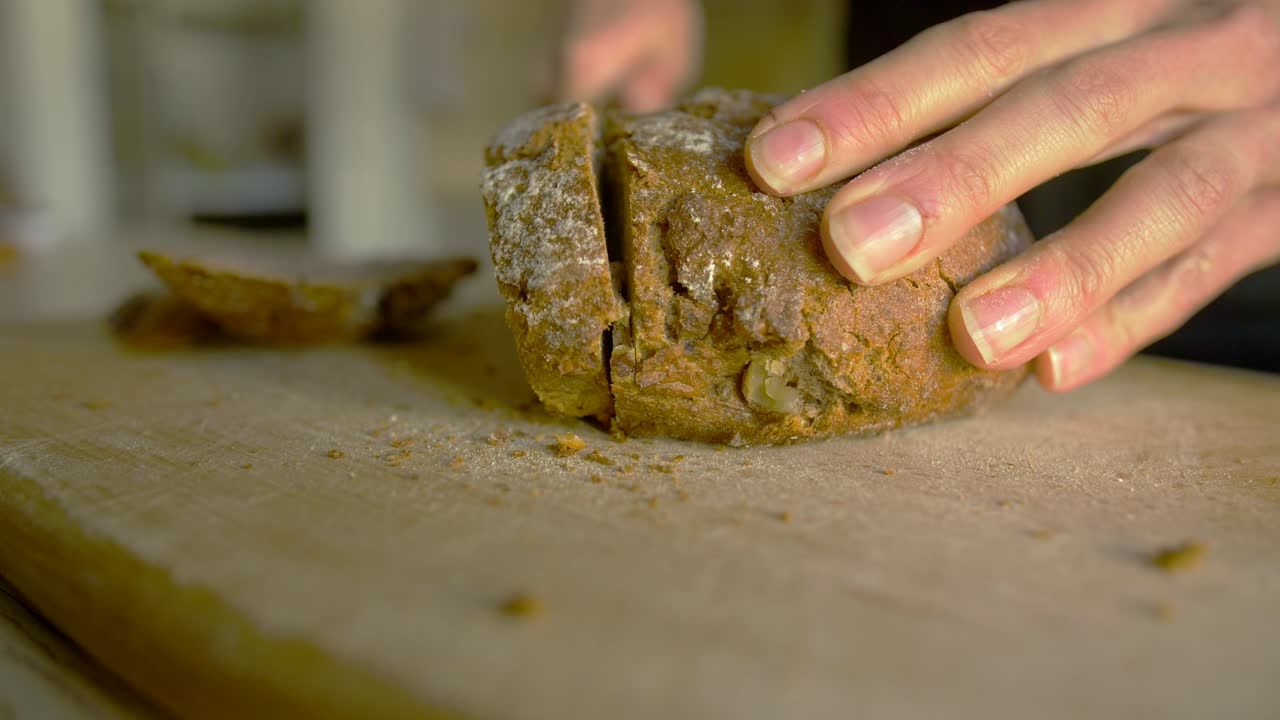 Close up of white woman cutting buckwheat bread