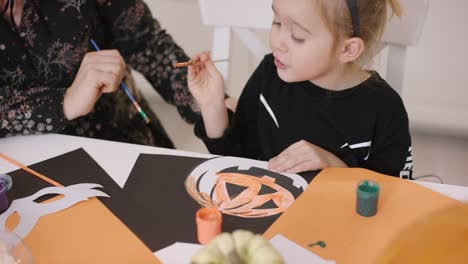 girl painting pumpkin