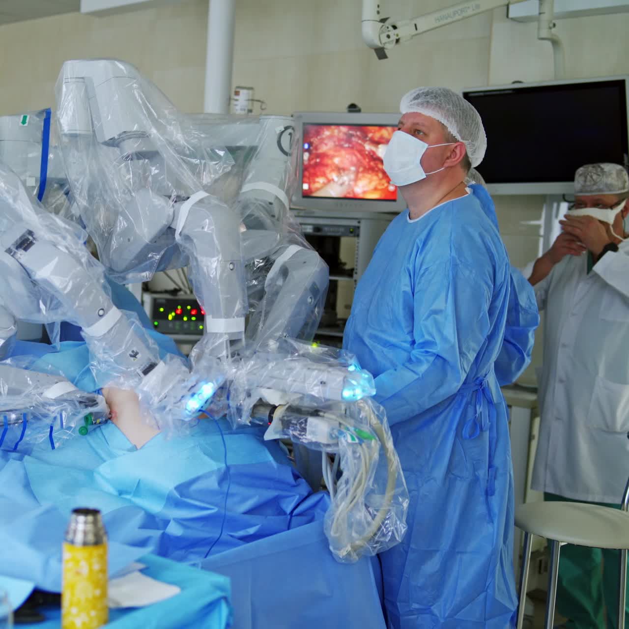 Surgical room in hospital with robotic equipment. Machine arm in futuristic operating room doing minimal invasive surgery. Specialist controls the work of medical robot.
