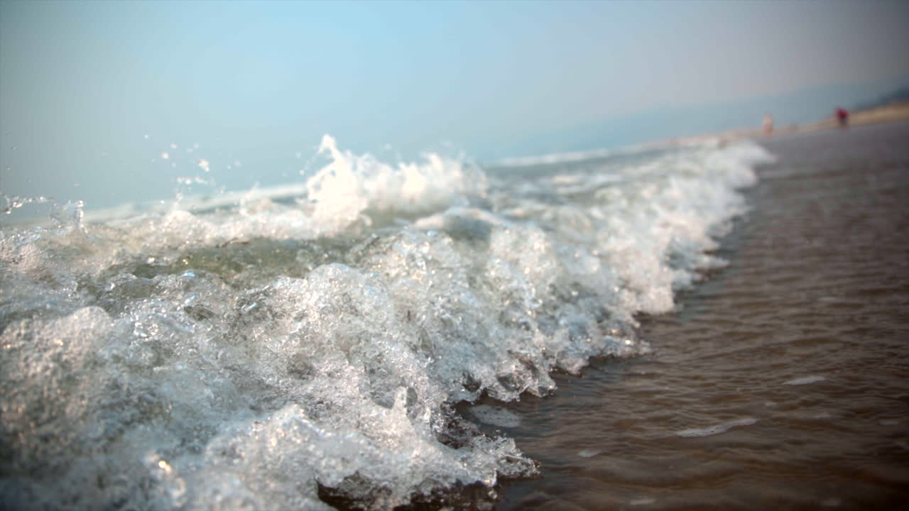 Waves crashing on beach in slow motion. Oregon beach Canon Beach