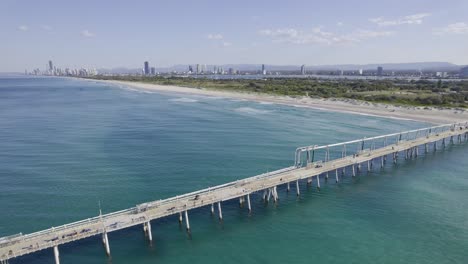 aerial view of sand bypass pumping jetty and the spit beach in gold coast, qld, australia