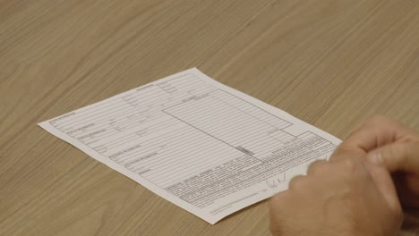 Close-Up-Shot-of-a-Customer-Signing-a-Bill-of-Sale-Contract-and-Receiving-the-Keys-to-his-New-Car