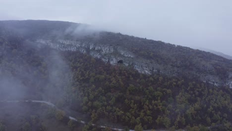 approaching drone shot and panning above the kozarnika cave, located in the balkan mountain range, in dimovo municipality, in bulgaria