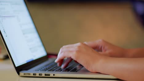 woman's hands programming on laptop close up