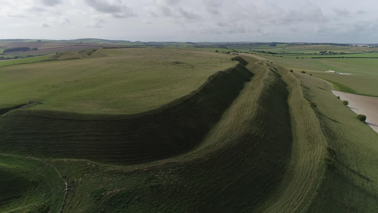 Aerial view of a green landscape with fields and hills